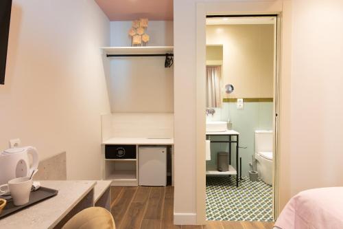 a small bathroom with a sink and a toilet at Boutique Rooms Playa Burriana in Nerja