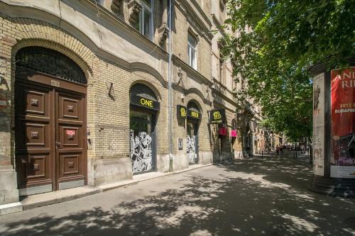 an empty street in front of a building at Karikum Small in Budapest
