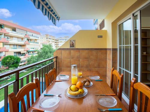 a table with a plate of fruit on a balcony at Apartment El apartamento de Noa by Interhome in Rincón de la Victoria