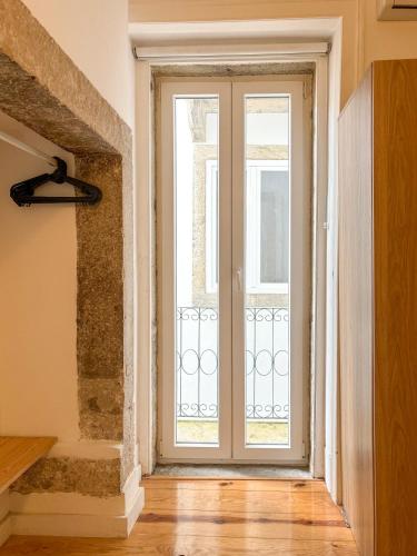 an empty room with a large glass door at Home Mais 36 in Lisbon