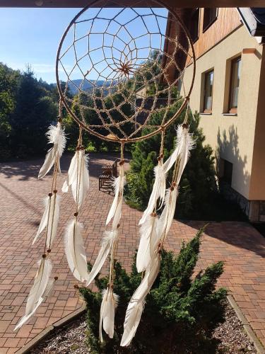 a bunch of white feathers hanging from a hoop at Penzion Ema in Šumperk