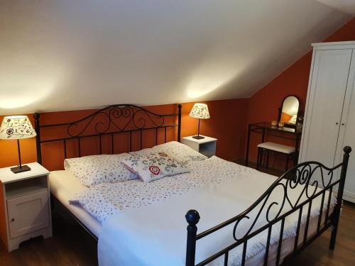 a bedroom with a large bed with a wooden headboard at Penzion Ema in Šumperk