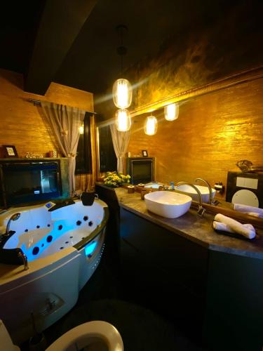a bathroom with a tub and a toilet and a sink at Mystik Penthouse in Sighişoara