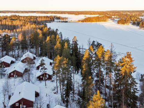 an aerial view of a snowy village with trees and a lake at Holiday Home Rustholli 9 by Interhome in Tampere