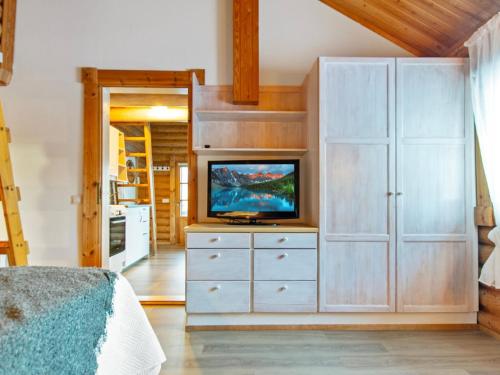 a bedroom with a tv and a white cabinet at Holiday Home Rustholli 9 by Interhome in Tampere