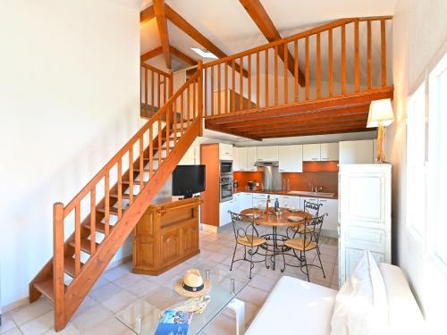 uma cozinha com uma escada e uma mesa com cadeiras em Holiday Home Green Village-4 by Interhome em Roquebrune-sur-Argens