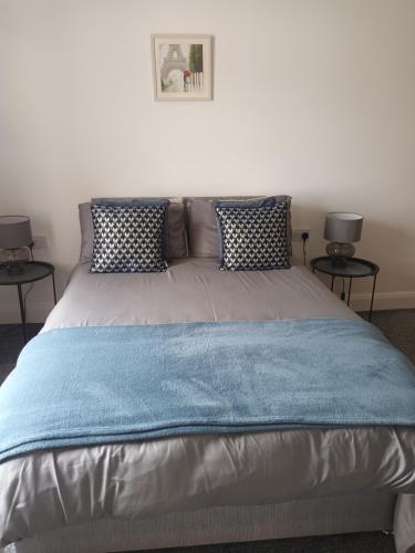 a bedroom with a large bed with two tables at Birdhill Farmhouse in Tipperary
