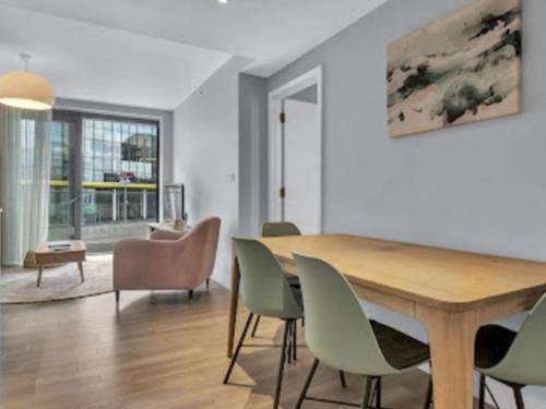 a dining room with a wooden table and chairs at Apartment Wembley Park apartments-2 by Interhome in London
