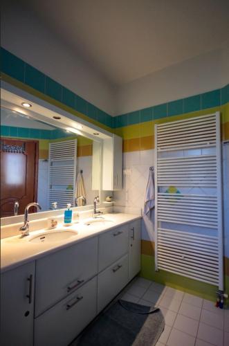 a bathroom with two sinks and a large mirror at Villa Sofia in Samos