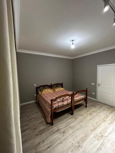 a bedroom with a bed in the corner of a room at NURAS-APART in Kirovo