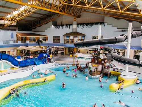 a group of people in a pool at a water park at Luxury Hot Tub Lodge 5 Star Country Park Huge Veranda Colour Change Hot Tub Private Fishing FREE Parking in Malton