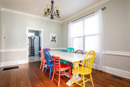 a dining room with a table with colorful chairs at Historic 3 Bedroom Home in Jacksonville