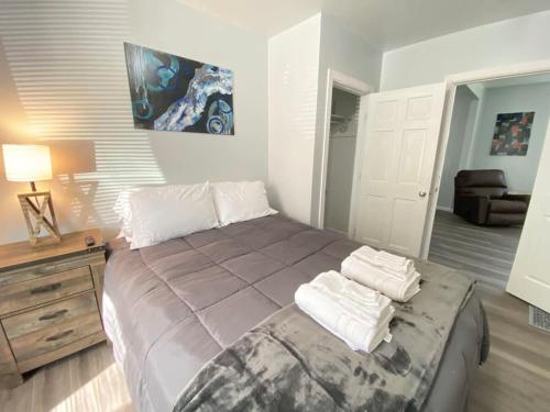 a bedroom with a large bed with towels on it at 3rd Base Apt 1 All Star Baseball Rentals in Oneonta