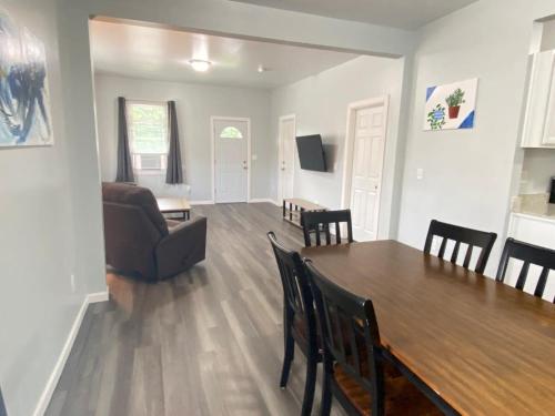 a living room and dining room with a table and chairs at 3rd Base Apt 1 All Star Baseball Rentals in Oneonta