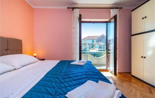 a bedroom with a large bed and a large window at Apartment Serda in Ugljan