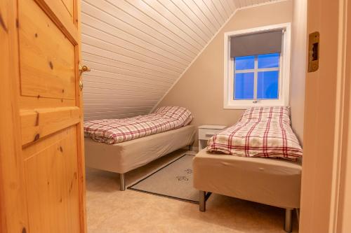 a room with two beds and a window at Lovely house in Tromso in Tromsø