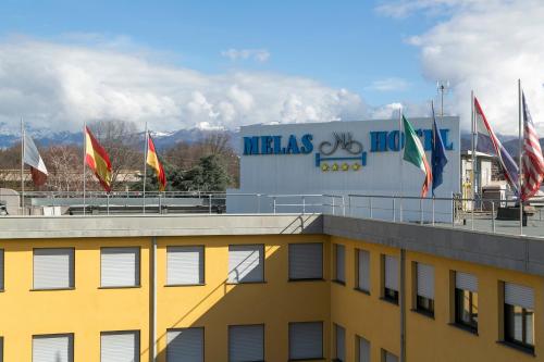 a building with flags on top of a building at Melas Hotel in Merate