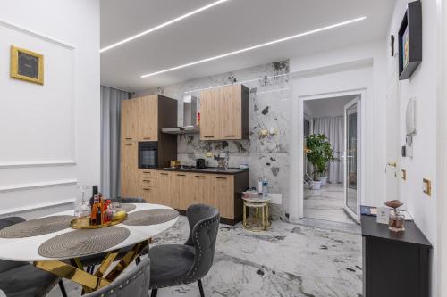 eine Küche und ein Esszimmer mit einem Tisch und Stühlen in der Unterkunft Maison 31 -Luxury Apartments in Santa Marinella