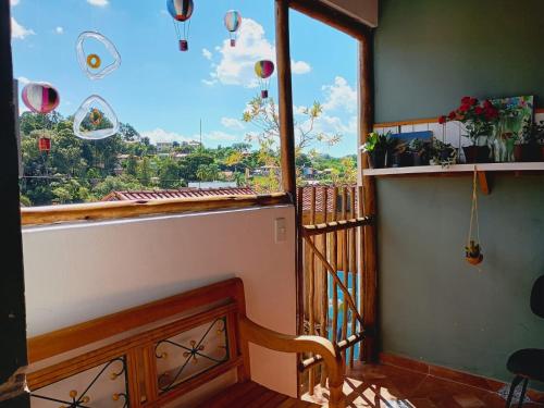 a balcony with a large window with a view at hospedagem Manaká proximo ao Centro vista incrível in Cunha