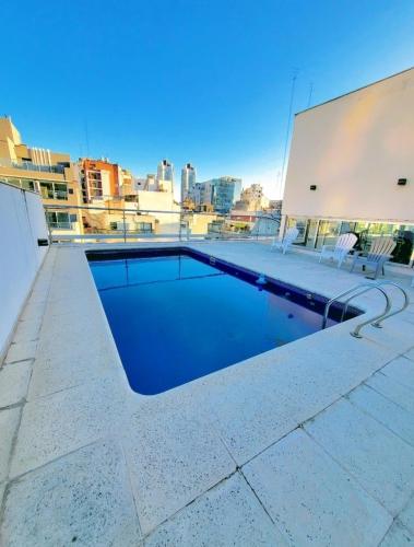 a swimming pool on the roof of a building at CABELLO SQUARE Security 24hs in Buenos Aires