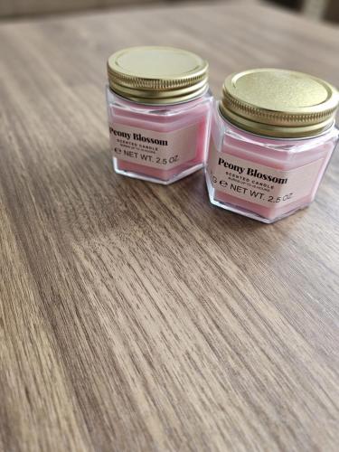 two jars of pink candles sitting on a table at Cozy 2 bed flat in London