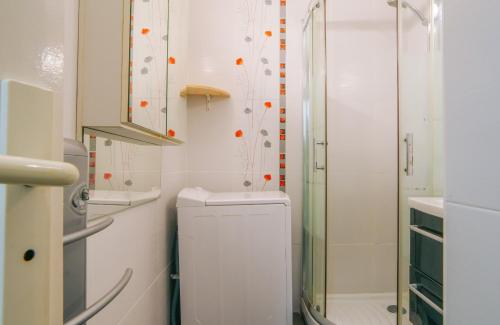 uma casa de banho branca com um chuveiro e um WC. em Zirlingua Bidart - magnifique appartement 2 pieces em Bidart