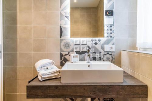 a bathroom with a sink and a mirror at B&B A Un Passo Dal Lago, Caldonazzo in Caldonazzo
