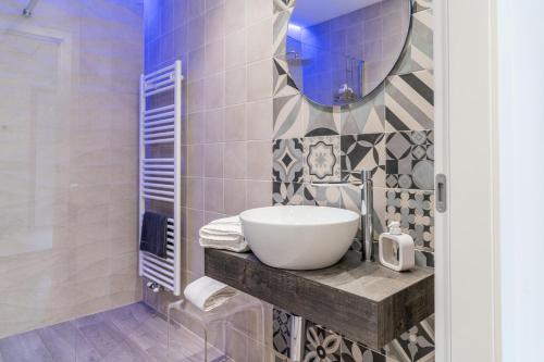 a bathroom with a sink and a mirror at B&B A Un Passo Dal Lago, Caldonazzo in Caldonazzo