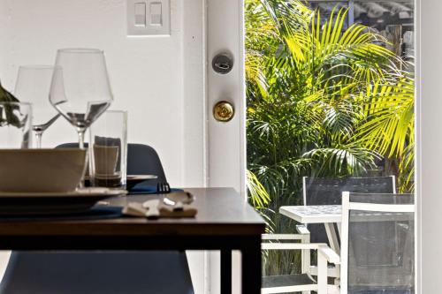 a table with wine glasses on top of it at Lovely Rental Unit with free Parking on Premises in Fort Lauderdale