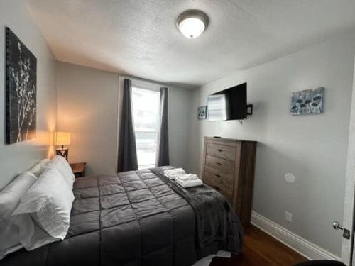 a bedroom with a large bed and a window at Home Plate Apt 1 All Star Baseball Rentals in Oneonta