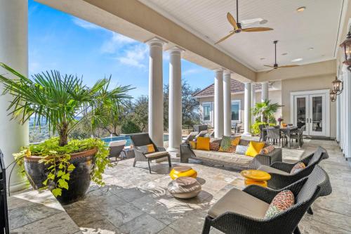 a patio with couches and tables and chairs at Fortaleza l Luxury 8 BR, 7,000+ sqft Palace on 3 Acres with Pickleball & Basketball Court in Helotes
