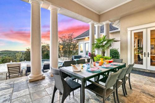 a dining room with a table and chairs on a patio at Fortaleza l Luxury 8 BR, 7,000+ sqft Palace on 3 Acres with Pickleball & Basketball Court in Helotes