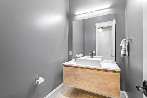 a bathroom with a white sink and a mirror at Fortaleza l Luxury 8 BR, 7,000+ sqft Palace on 3 Acres with Pickleball & Basketball Court in Helotes