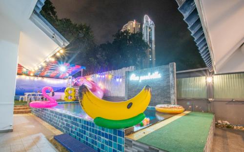 a room with a fake banana on a wall at Blue Pool Villa Jomtien / 350m to beach / Big Pool with Slider in Jomtien Beach