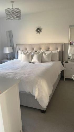 a bedroom with a bed with white sheets and pillows at 3 bedroom detached house in Cononbridge