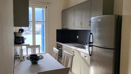 a kitchen with a stainless steel refrigerator and a table at Eirini Home in Andros