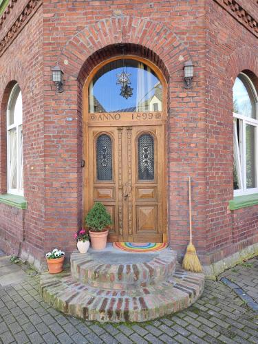 a wooden door on a brick building with plants at Apartment 58- Ruhr Nah in Essen