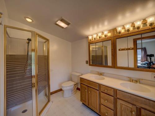 a bathroom with two sinks and a shower and a toilet at Left Field All Star Baseball Rentals in Oneonta