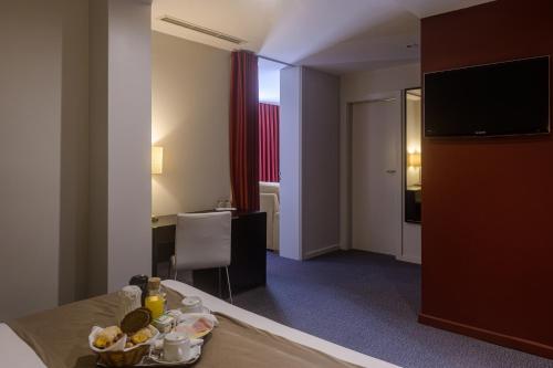a hotel room with a table with food on it at Hotel Torre Mar in Póvoa de Varzim