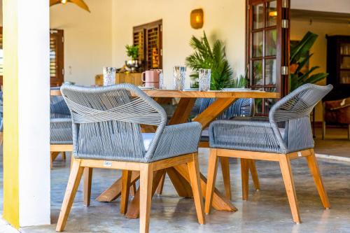 a wooden table with two chairs and a wooden table with a tableablish at Boutique Hotel Wanapa - Adult Friendly - 14 years and older in Kralendijk