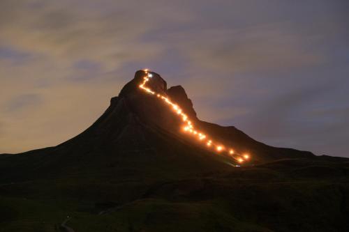 a mountain with lights on it at night at Alpine Lifestyle Berghotel Madlener in Damuls