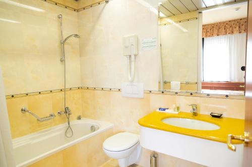 a bathroom with a sink and a toilet and a shower at Melas Hotel in Merate