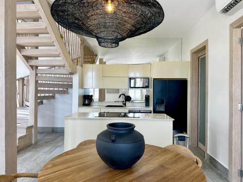 a kitchen with a vase sitting on a wooden table at AmazINN Places Casa del Mar in Panama City