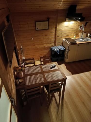 a room with a table and chairs and a sink at Spiska Dolina in Łapsze Niżne