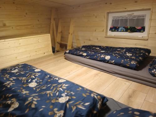 a bedroom with two beds in a wooden room at Spiska Dolina in Łapsze Niżne