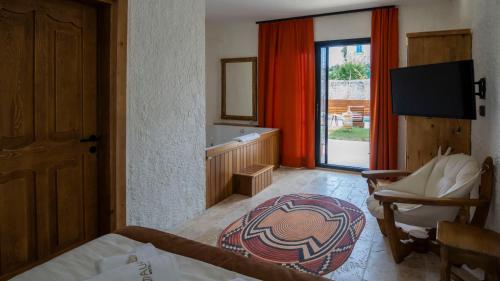 a bedroom with a bed and a tub and a window at Aura Village Alaçatı in Alacati