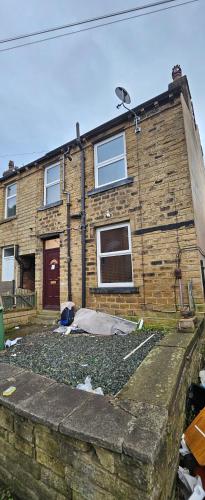 a brick house with a mattress in front of it at The Luxe - Entire House in Huddersfield