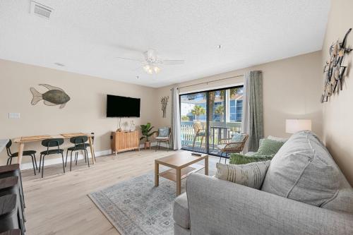 a living room with a couch and a table at Newly Renovated Condo with Beach access steps away in Myrtle Beach