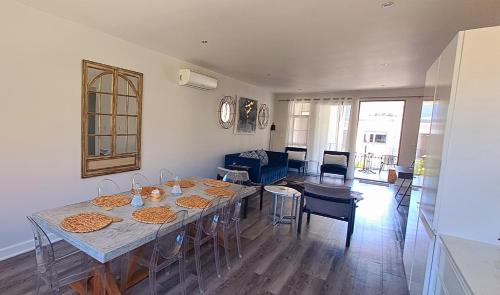 a dining room and living room with a table and chairs at 700m From Franschhoek Center in Franschhoek