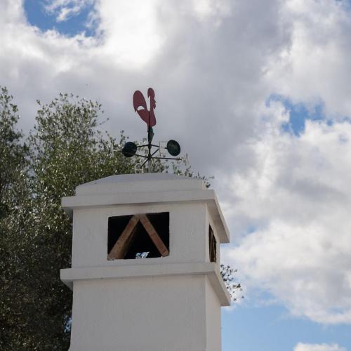 a tower with a weather vane on top of it at Apartamento para pareja, Finca Contrabando. Sanlucar del Guadiana in Sanlúcar de Guadiana